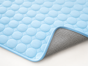 Détail du tapis Fraîcheur IceSilk bleu montrant la surface matelassée et le dessous antidérapant
